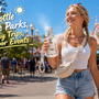 Woman carrying a cooling water bottle while walking through a hot theme park